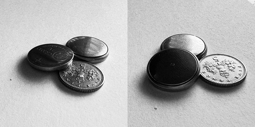 Two button batteries next to a 5p coin.