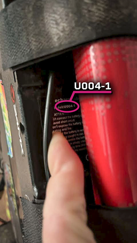 Shows the battery model number on a sticker that reads 'U004-1'